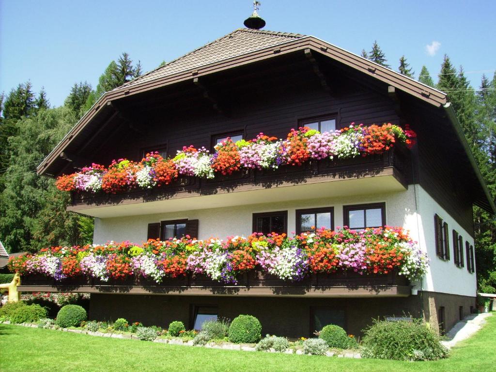 una casa con flores a un lado. en Haus Alpenland, en Sankt Andrä im Lungau