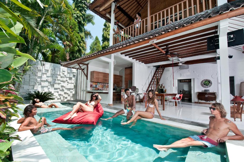 a group of people sitting in a swimming pool at 3BR Villa Hari - Minggu Villas Seminyak in Seminyak