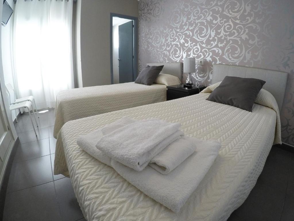 Posteľ alebo postele v izbe v ubytovaní Hostal Mediterráneo