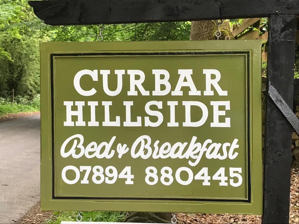 a sign that reads cumber bar wildlife bed and breakfast at Curbar Hillside B&B in Curbar