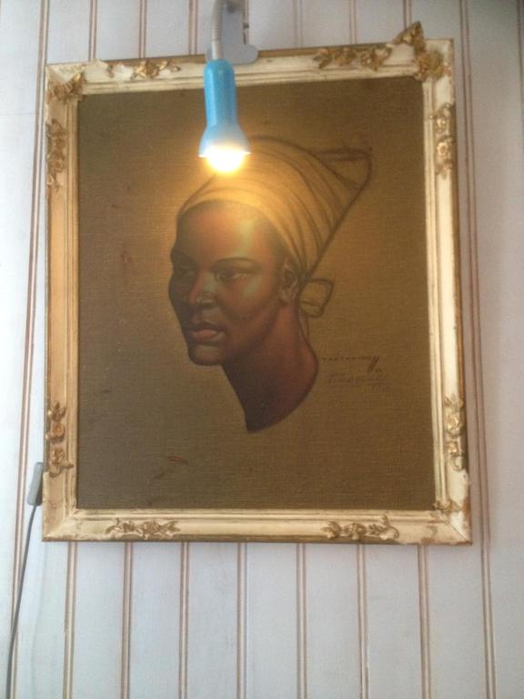 a painting of a woman in a hat with a light at TOPFLOOR Les Terrasses in Dieppe