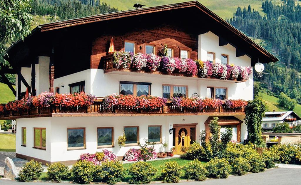 a house with flower boxes on the side of it at Appartements Schwarzer Adler in Elbigenalp