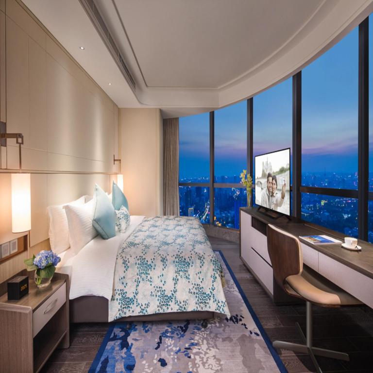 Letto o letti in una camera di Ascott Harmony City Nantong