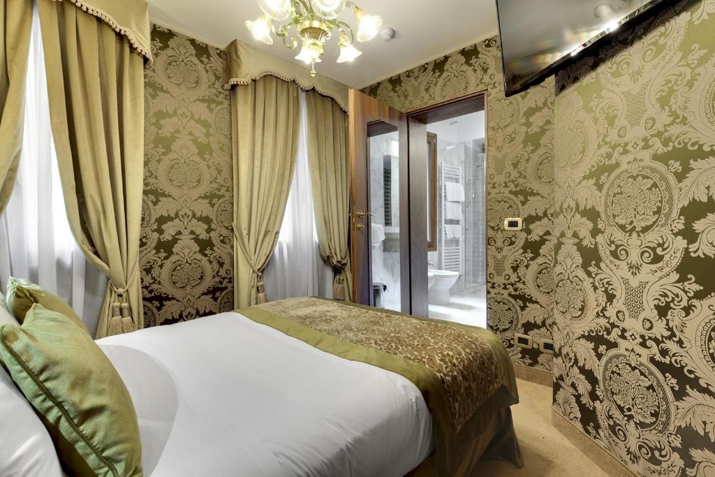 Postel nebo postele na pokoji v ubytování Hotel Casanova