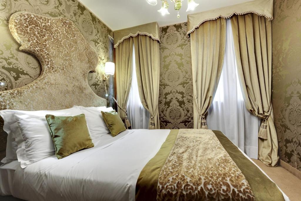 Postel nebo postele na pokoji v ubytování Hotel Casanova
