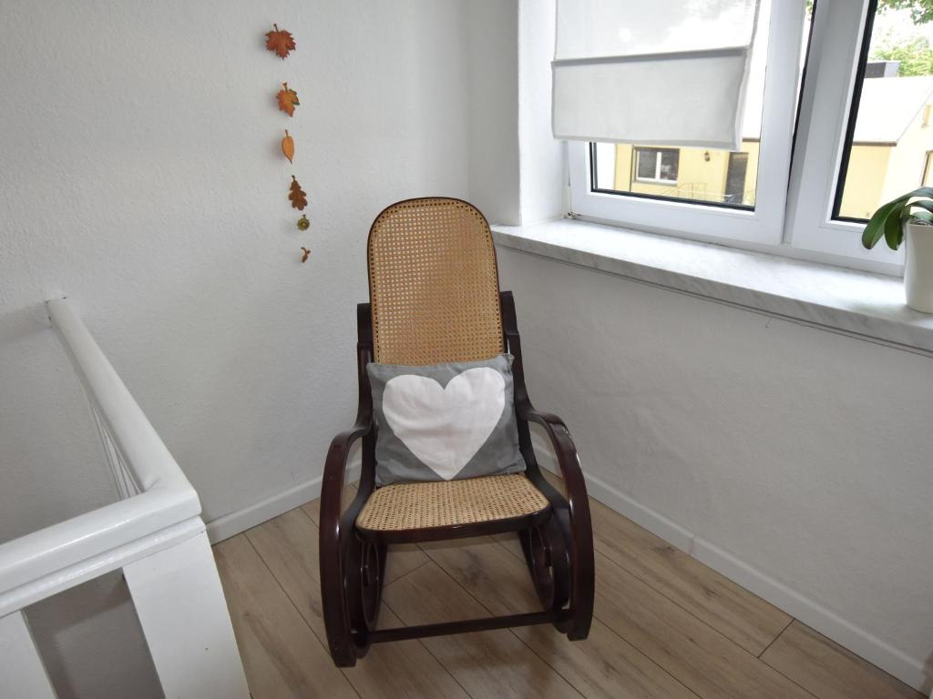 a chair in a room with a window at Cozy Apartment in Neubukow near Water Sports in Neubukow