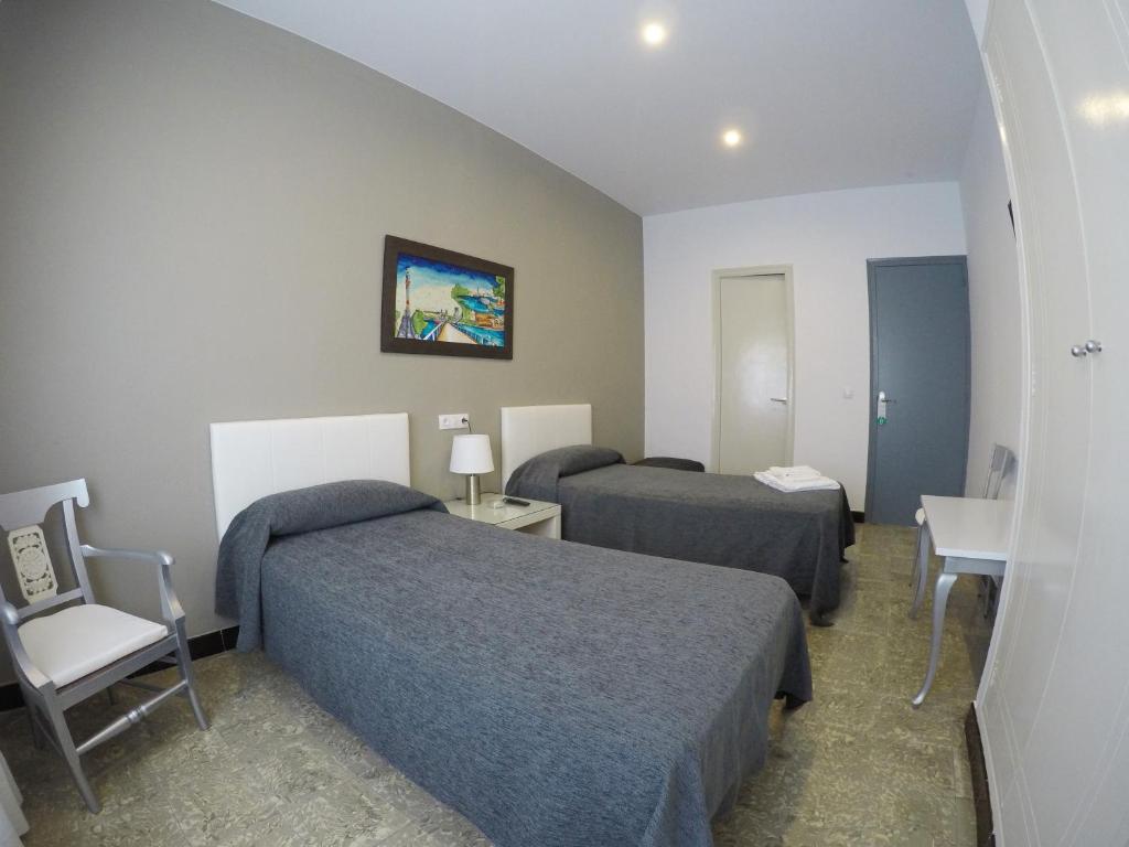 Posteľ alebo postele v izbe v ubytovaní Hostal Mediterráneo