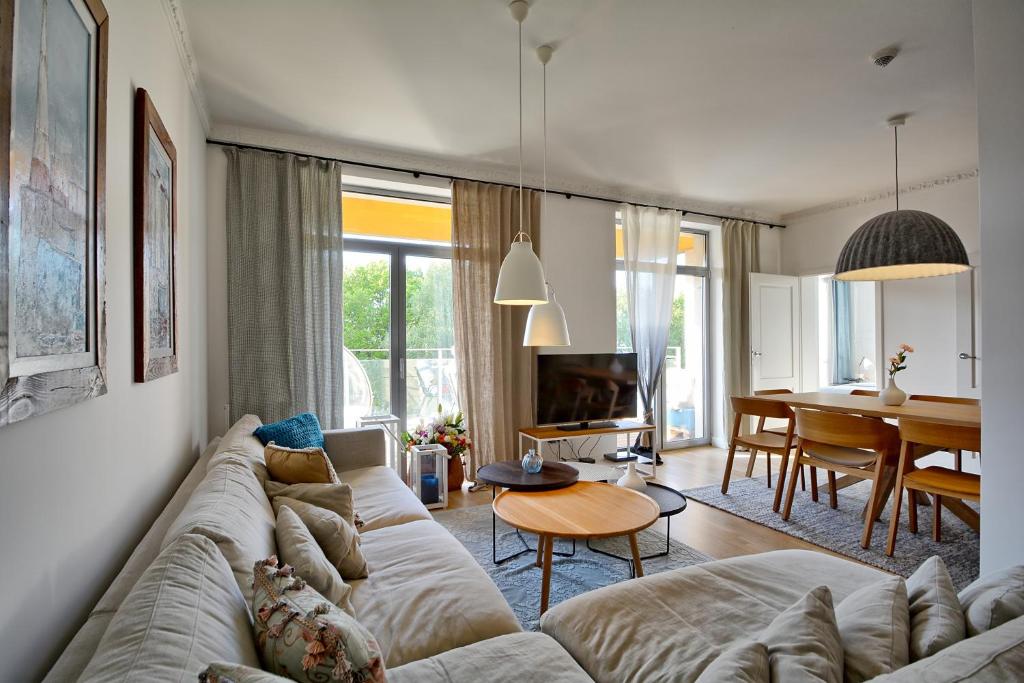 a living room with a couch and a dining room at Private apartment Sulkowskiego in Kołobrzeg