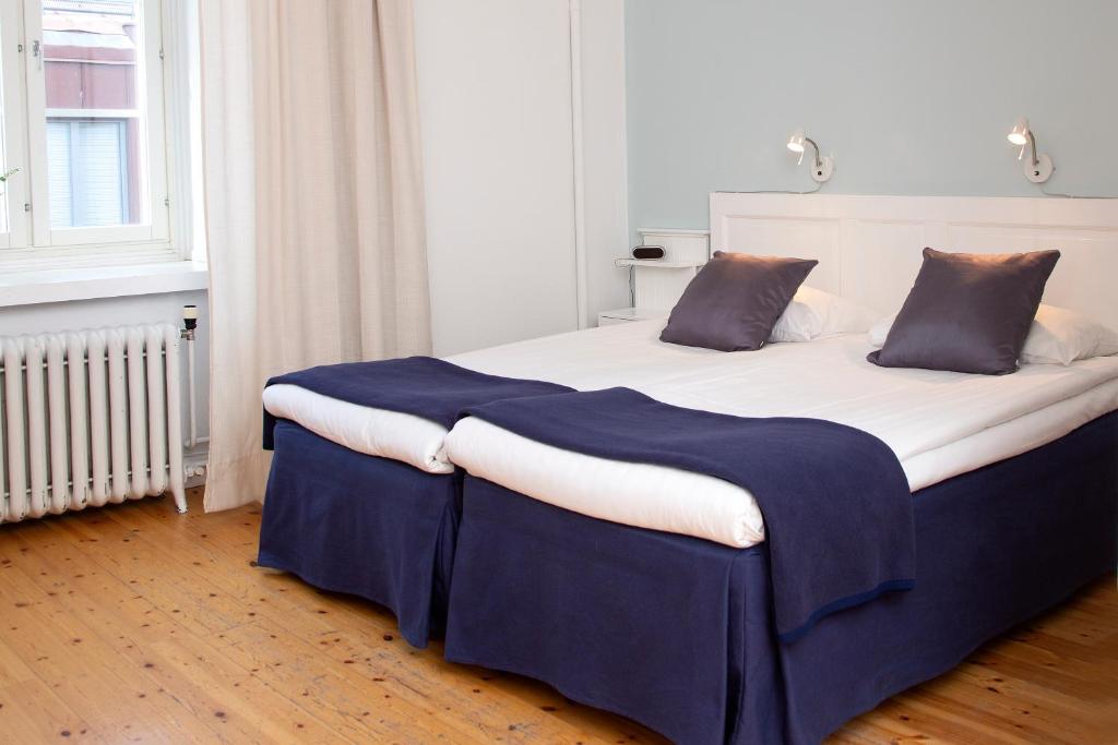 Postel nebo postele na pokoji v ubytování Hotel Emma