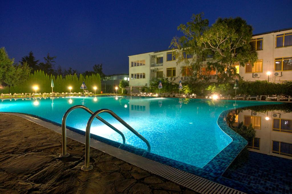 a large swimming pool at night with lights at Strandzha Hotel - Free Parking in Golden Sands