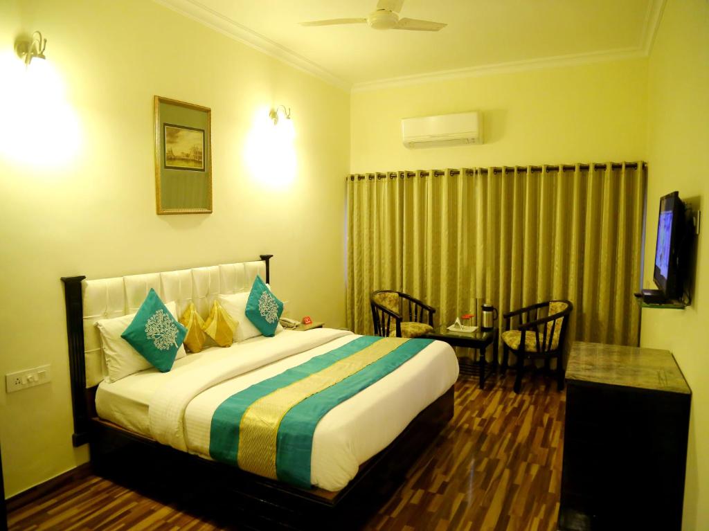 A bed or beds in a room at Akashdeep 22