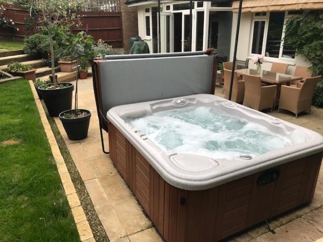 a large hot tub sitting in a yard at Wimbledon Tennis House with Hot Tub; 4 minute walk in London
