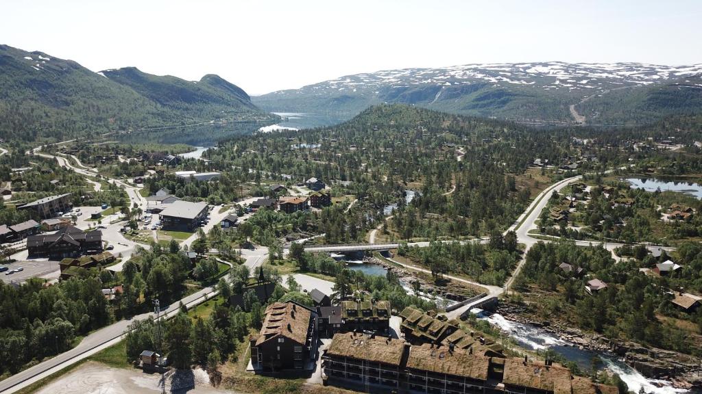 an aerial view of a town with a river and mountains at Hovdehytta in Hovden