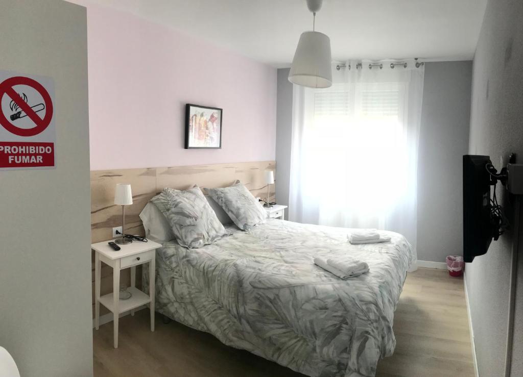 Postel nebo postele na pokoji v ubytování Alojamientos Olga