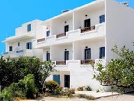 a large white building with trees in front of it at Esperis in Livadi Astypalaias