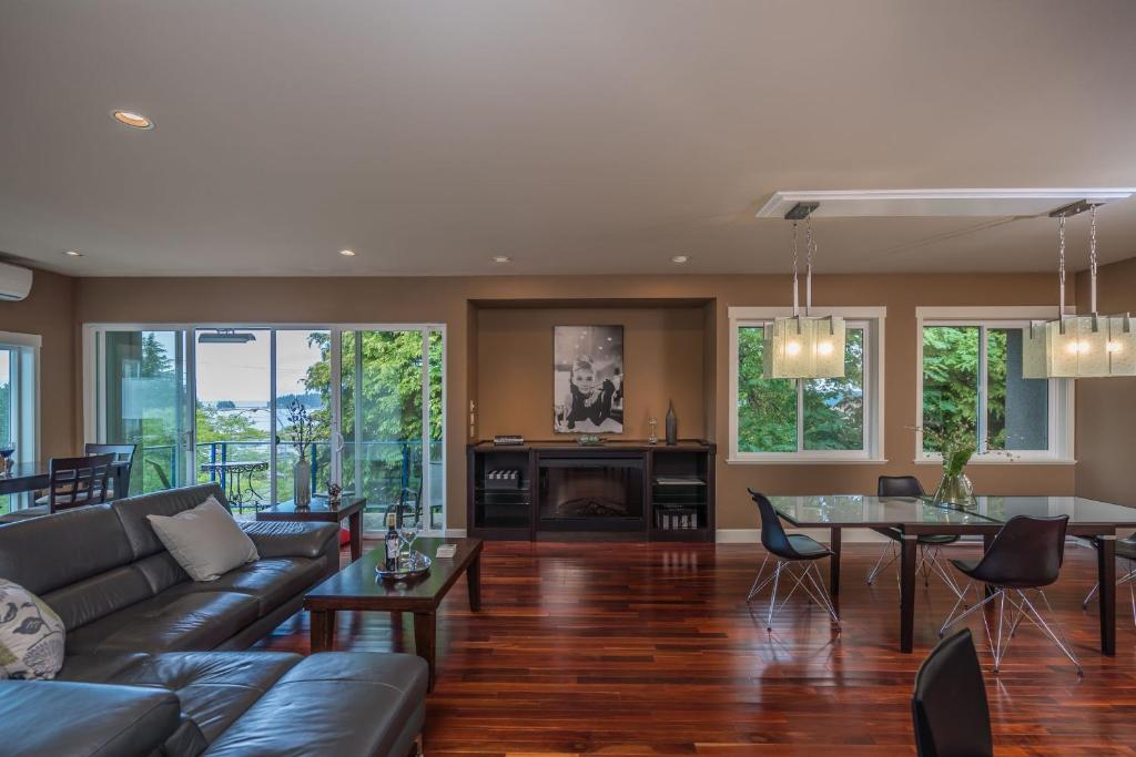 a living room with a couch and a table at Luxury Penthouse Downtown Nanaimo in Nanaimo