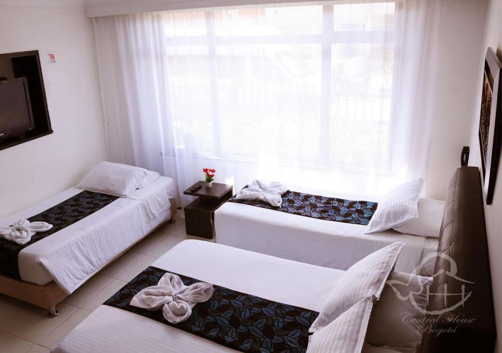 Postel nebo postele na pokoji v ubytování Hotel Central House a 5 min de la Embajada Americana