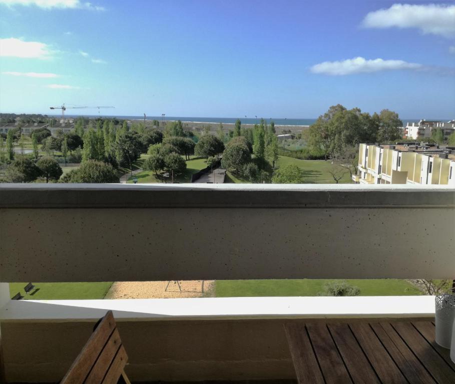 a balcony with a view of a park at Troia MaisMais apartamento in Troia
