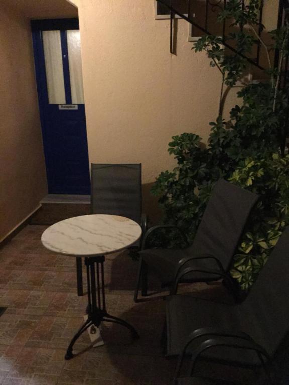a table and chairs in a room with a door at Eugenia travasarou sea view appartments in Diakofti