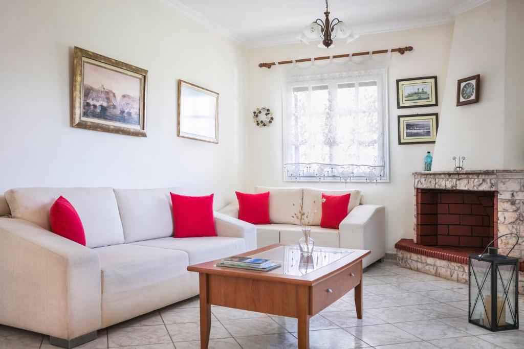 a living room with a couch and a fireplace at Apartment Voula Myrtos in Anomeriá