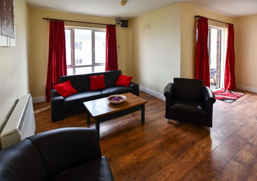 a living room with a couch and a table at Kilkee Bay Apartments in Kilkee