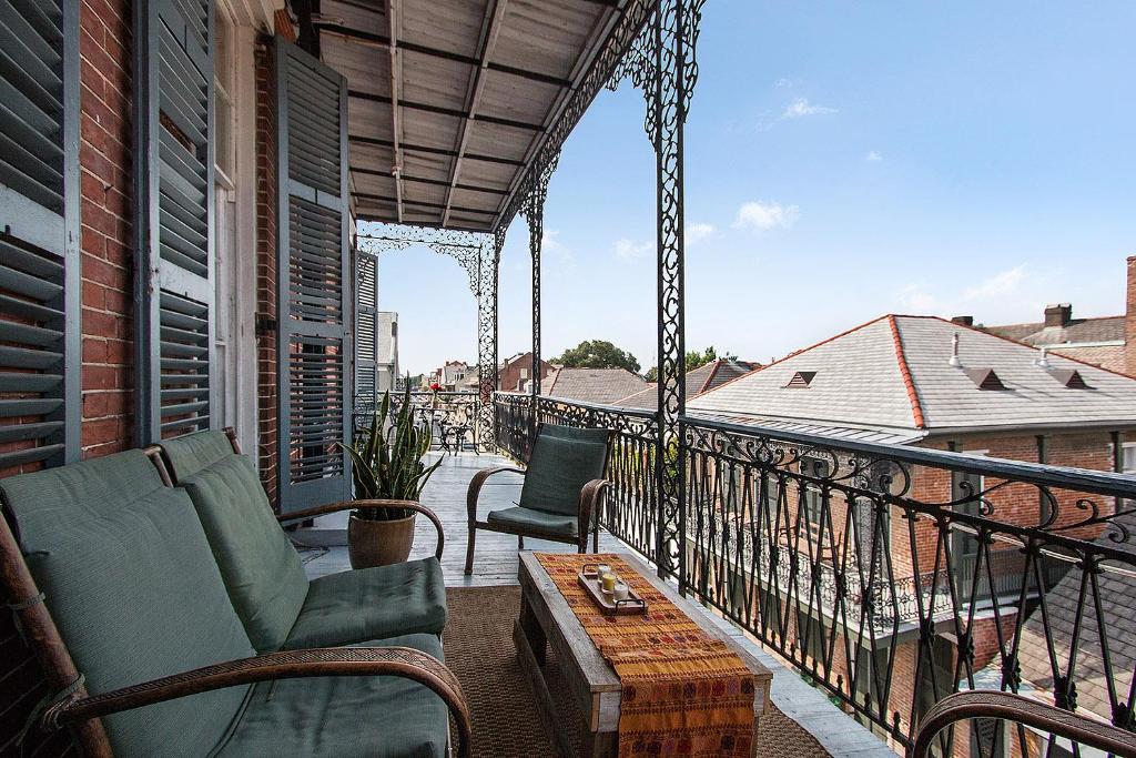 a balcony with a couch and a coffee table at French Quarter Mansion in New Orleans