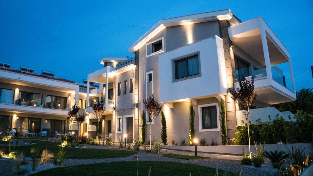 a large white building with a large window at Costa Domus Blue Luxury Apartments in Nikiti