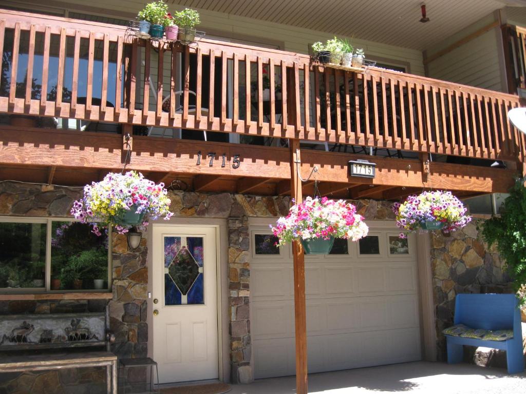 a house with two potted plants on the stairs at Bridal Veil Bed and Breakfast in Ouray