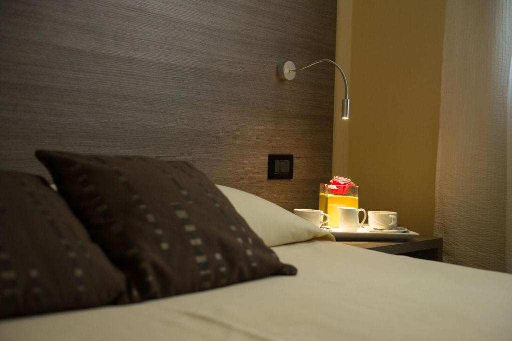 Postel nebo postele na pokoji v ubytování Albergo Grappolo D'oro
