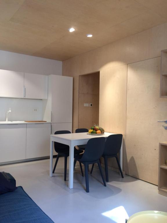 a kitchen with a white table and chairs in a room at Apartment P 35 in Dubrovnik