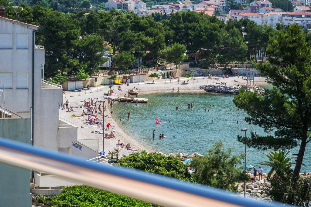 a beach with a bunch of people in the water at Rooms Zvonimir in Split