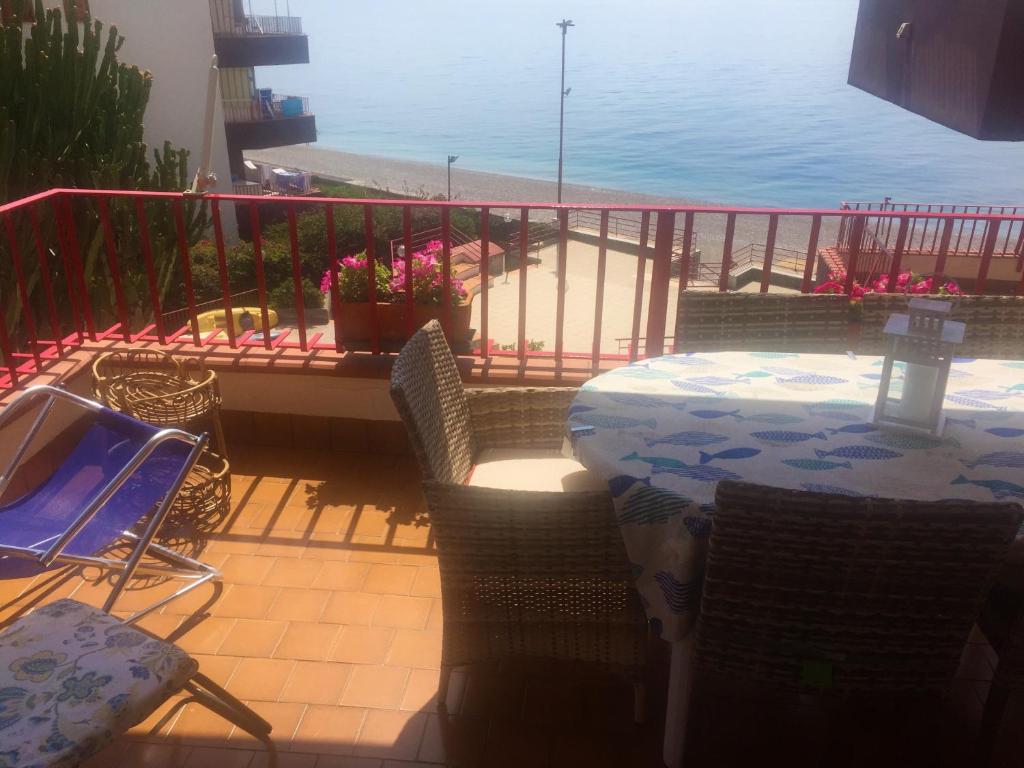 レトイアンニにあるSea Beach Taormina Apartmentsの海を望むバルコニー(テーブル、椅子付)