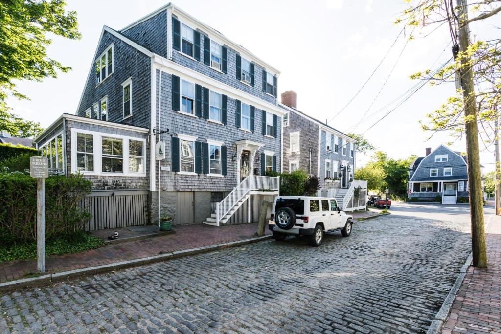 a white jeep parked in front of a house at Carlisle House Inn in Nantucket
