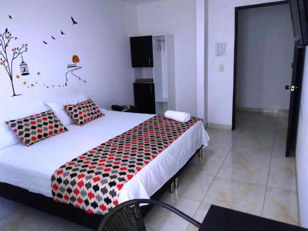 Postel nebo postele na pokoji v ubytování Hotel Cosmos Sincelejo