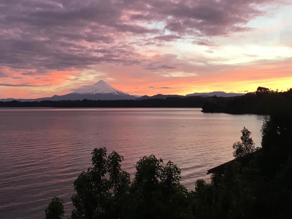 a view of a mountain on a lake at sunset at Cabañas Puerto Chalhuaco in Puerto Varas