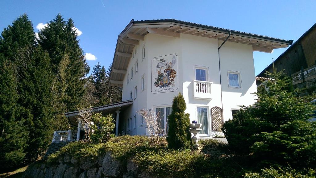 a white building with a mural on the side of it at Villa-Musica in Fieberbrunn