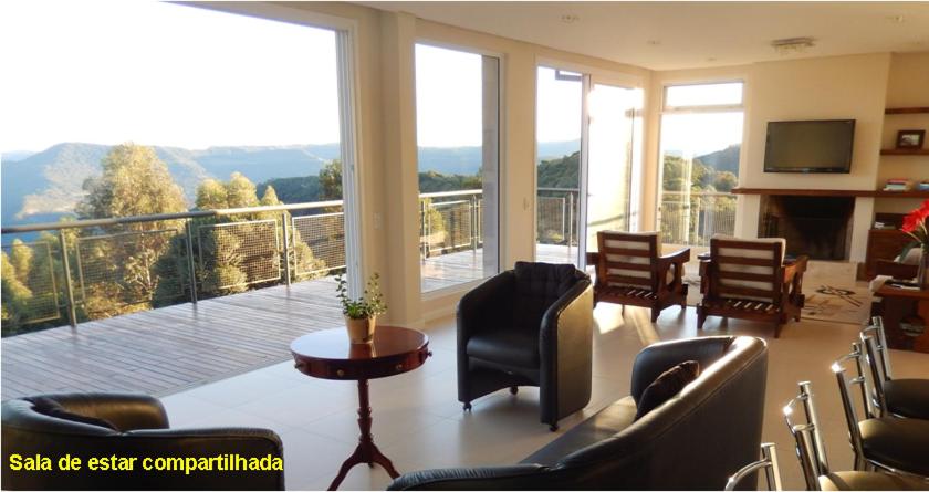 a living room with a view of a balcony at Casa Colina do Sol in Nova Petrópolis