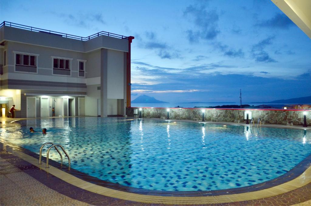 une grande piscine en face d'un bâtiment dans l'établissement MTC Mega Mas Apartment, à Manado