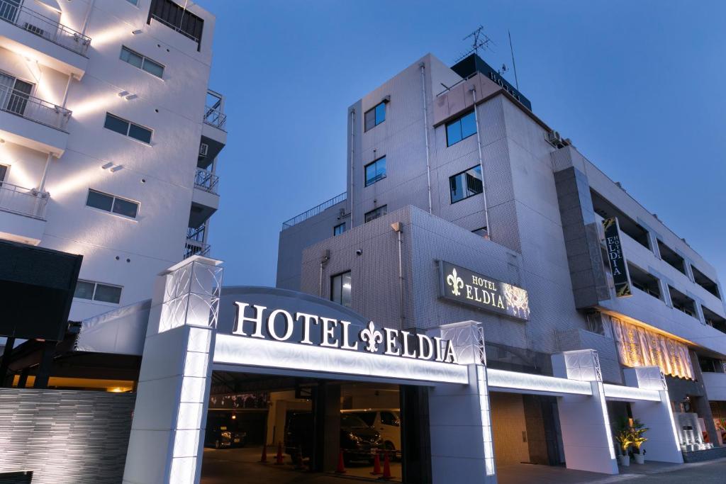 a hotel building with a sign in front of it at Hotel Eldia Luxury Kobe (Adult Only) in Kobe
