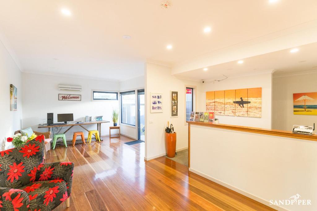 a living room with a couch and a table at Sandpiper Motel Apollo Bay in Apollo Bay