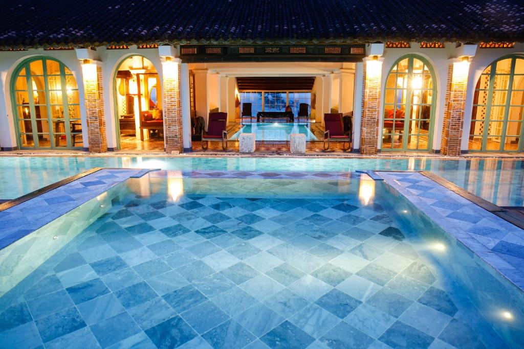 a swimming pool in the middle of a building at Villa Louise Hue Beach Boutique Hotel in Hue