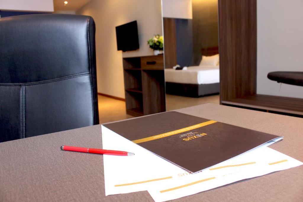 A desk with a leather chair, stationery and a bedroom mirror forms the room's work corner.