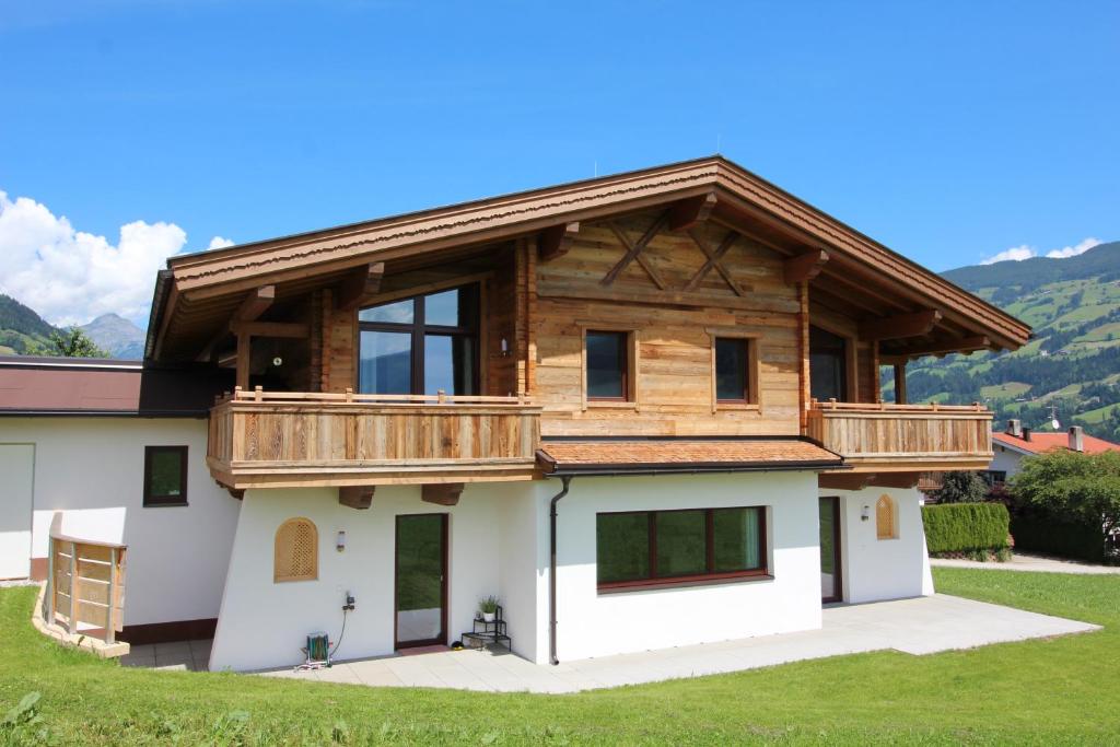 a large house with a wooden roof at Chalet Fügen in Fügen