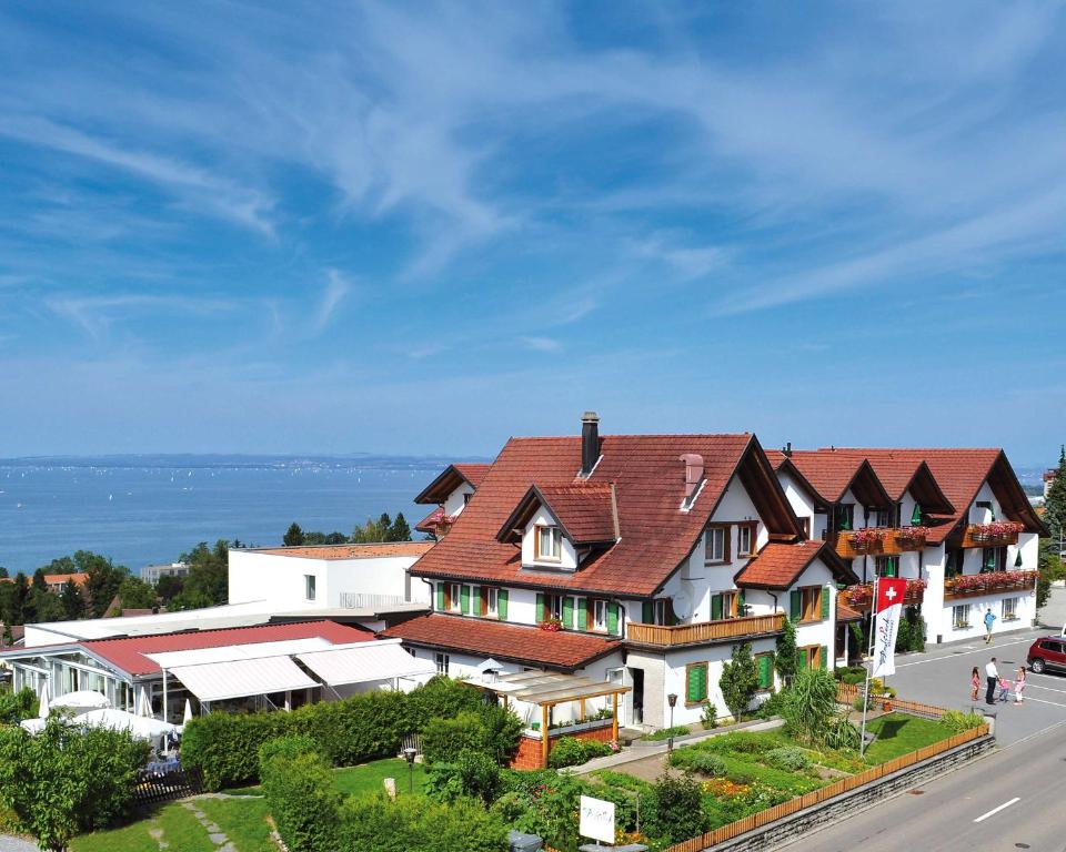 a large house with a red roof on a street at Best Western Hotel Rebstock in Rorschacherberg