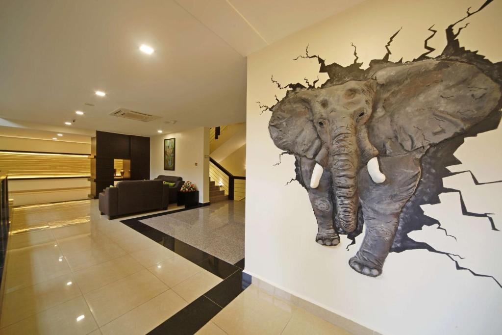 a mural of an elephant on a wall in a hallway at Best Western Premier Garden Hotel Entebbe in Entebbe