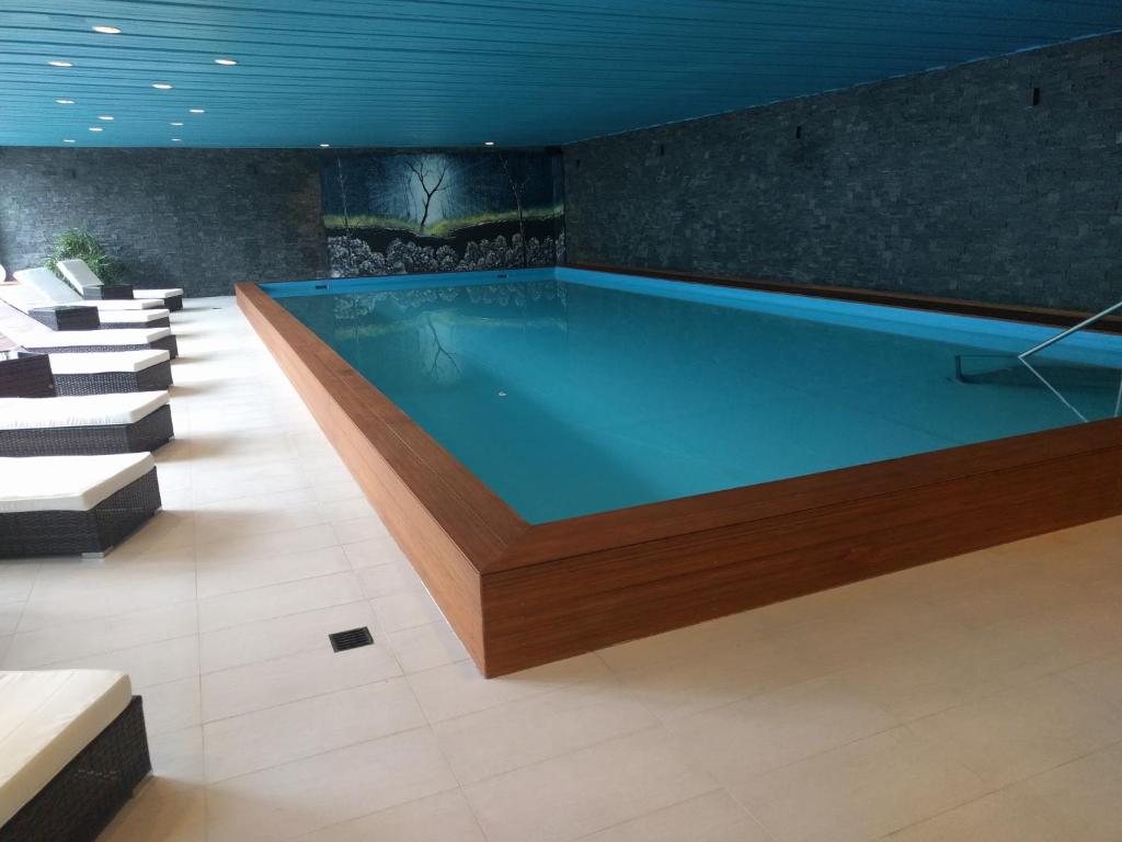 uma grande piscina num quarto com cadeiras em Holiday accommodation - swimming pool available em Davos