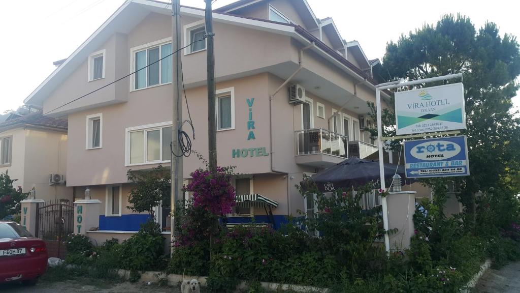 a building with a sign in front of it at VİRA HOTEL DALYAN in Dalyan