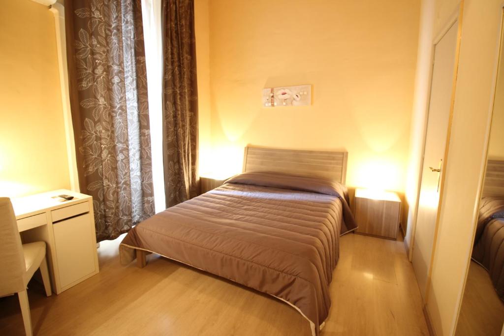 a small bedroom with a bed and a window at B&B Residenza Umberto in Catania
