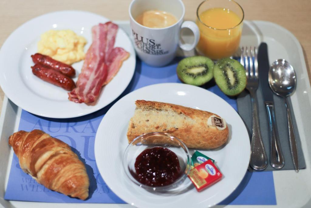 a tray with two plates of breakfast food on a table at KYRIAD ROUEN NORD - Mont Saint Aignan in Mont-Saint-Aignan