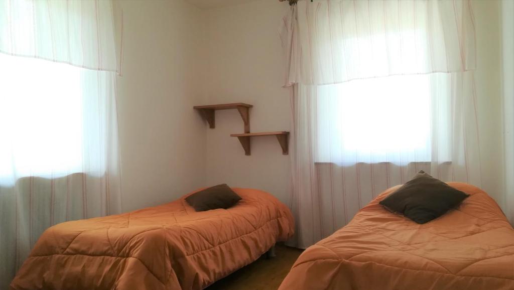 Postel nebo postele na pokoji v ubytování Hotel Tomei